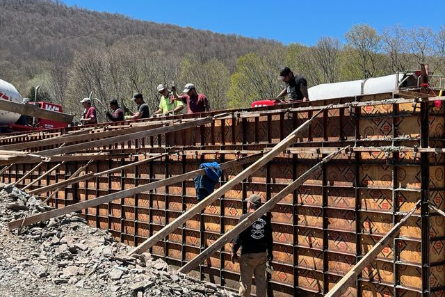 Crew and concrete truck at the foundation formwork