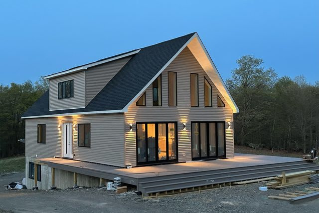 The finished house lit at dusk