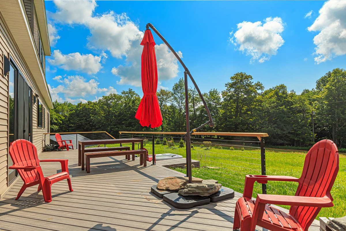 Red Adirondack chairs and outdoor dining on the deck