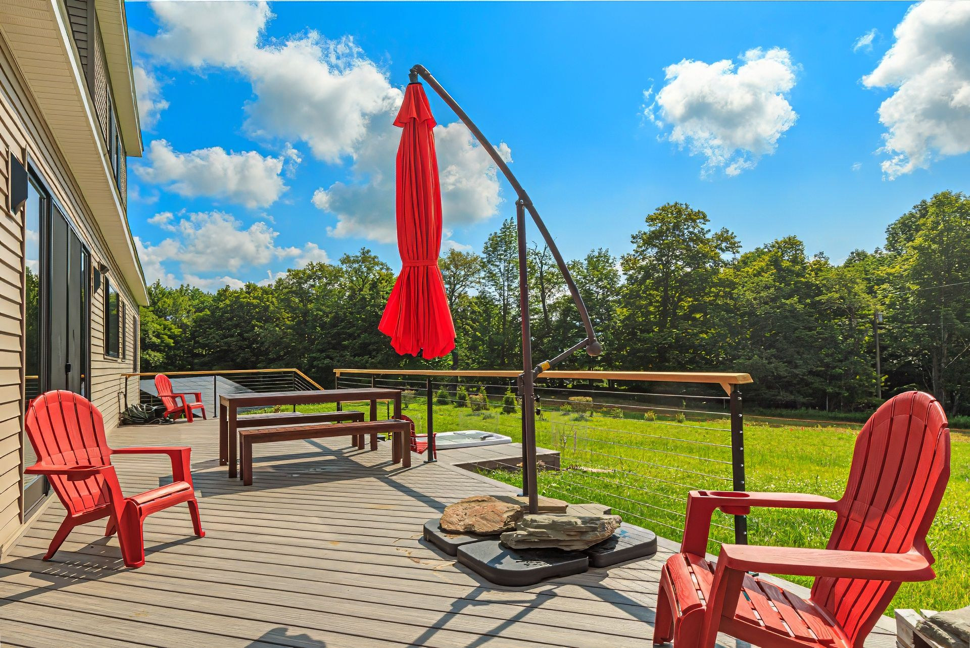 Red Adirondack chairs and outdoor dining on the deck