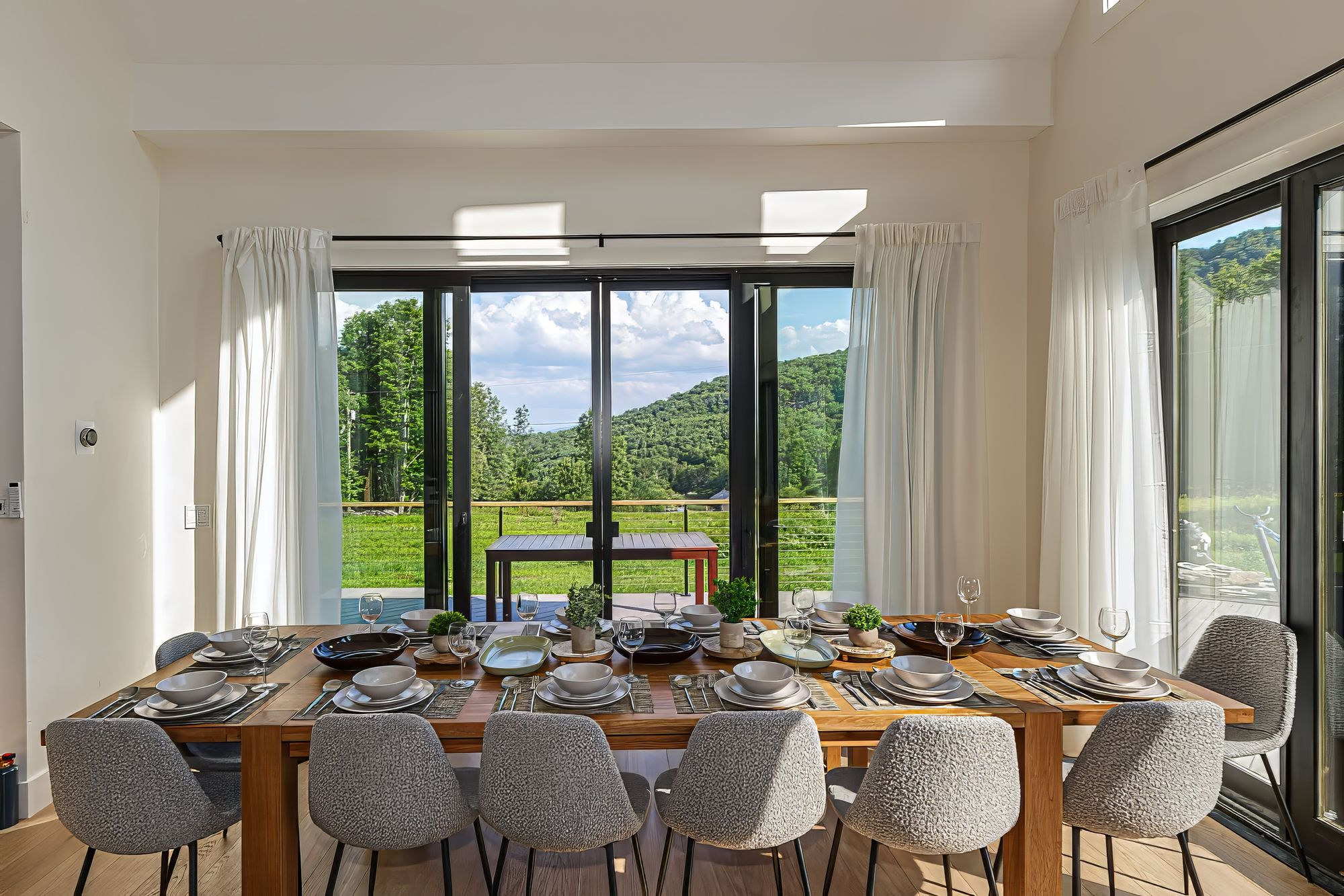 Long dining table beside walls of glass