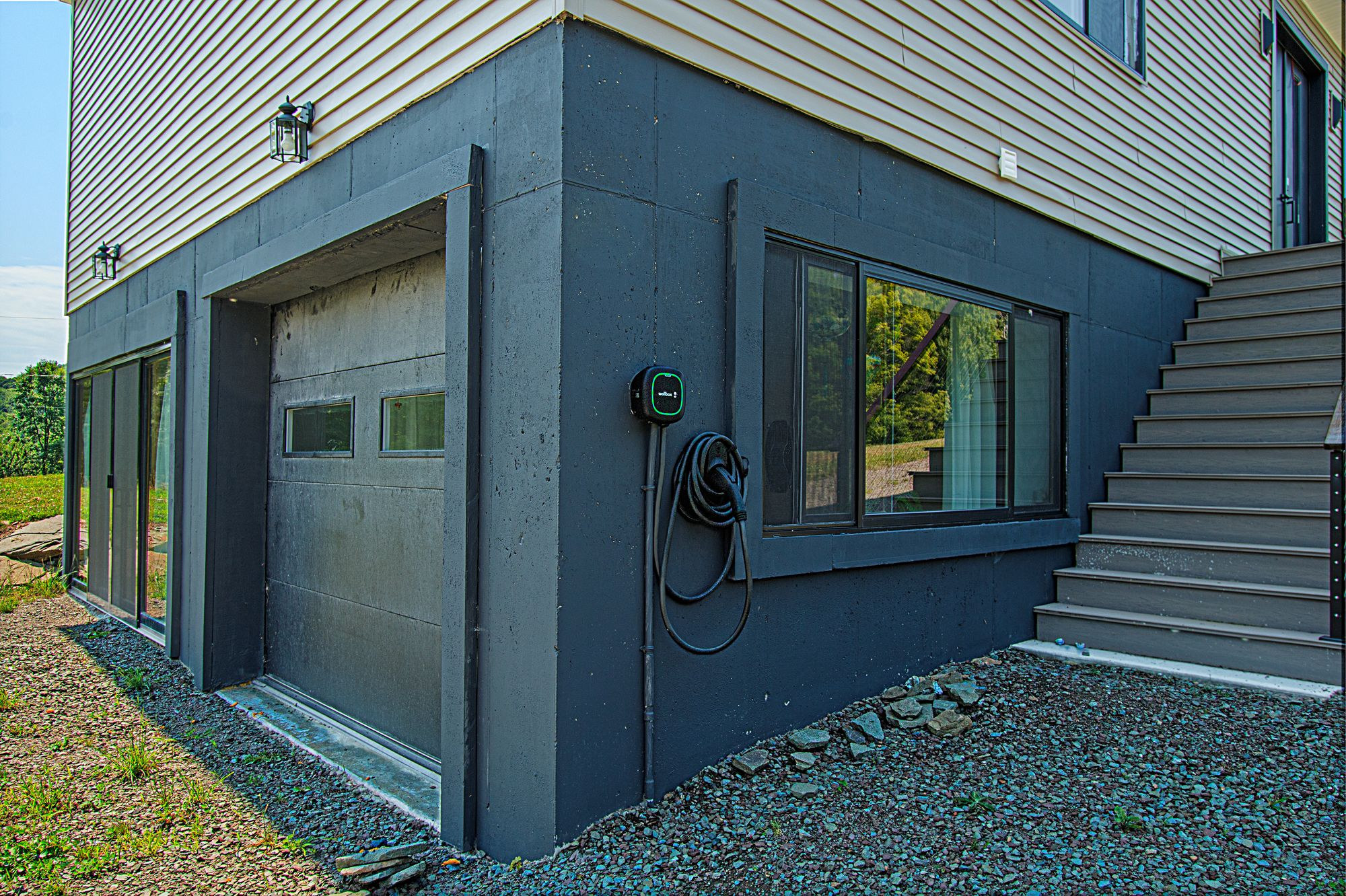 Level 2 EV charger mounted beside the garage door