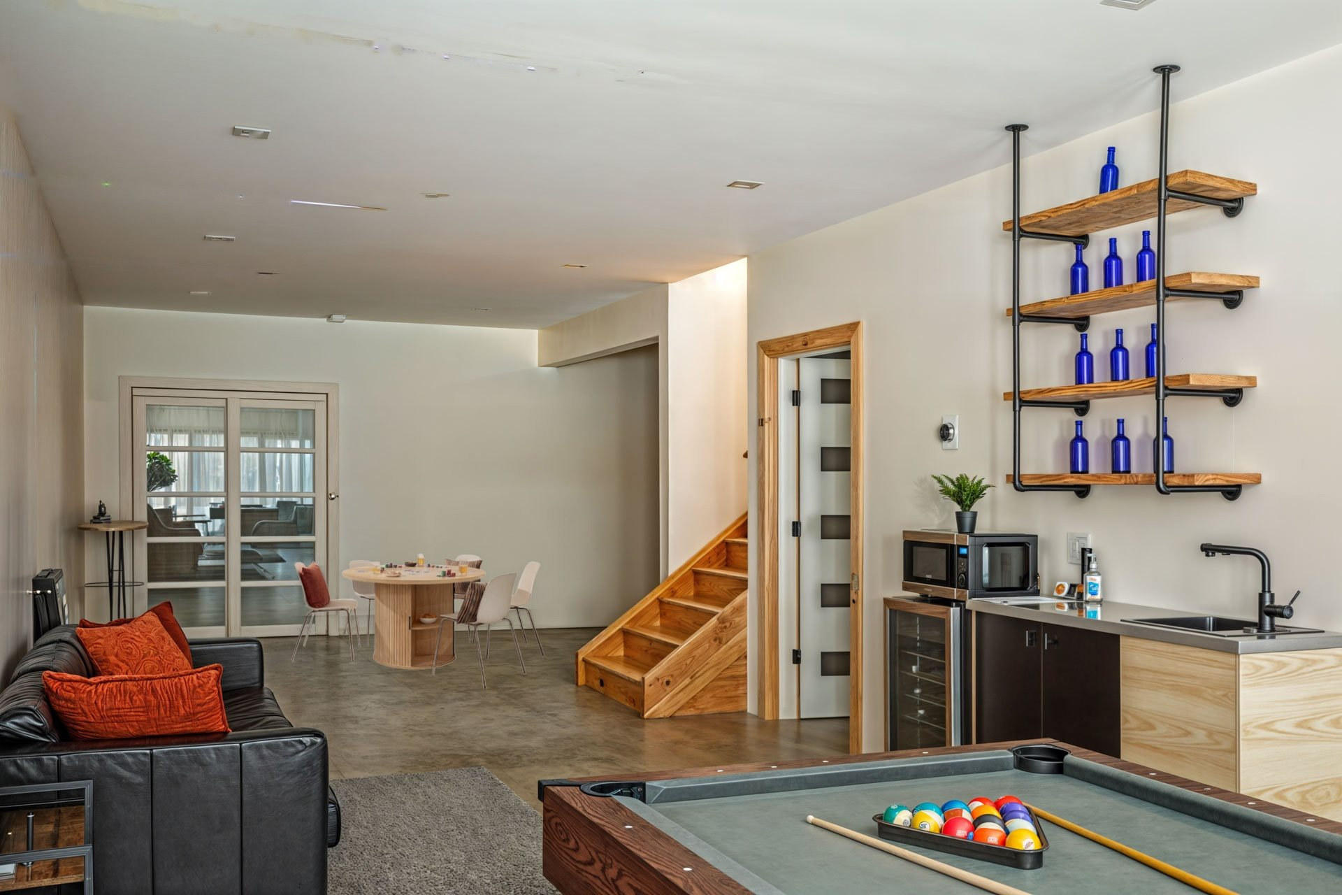 The Lower Level: wet bar, stairs, lounge and pool table