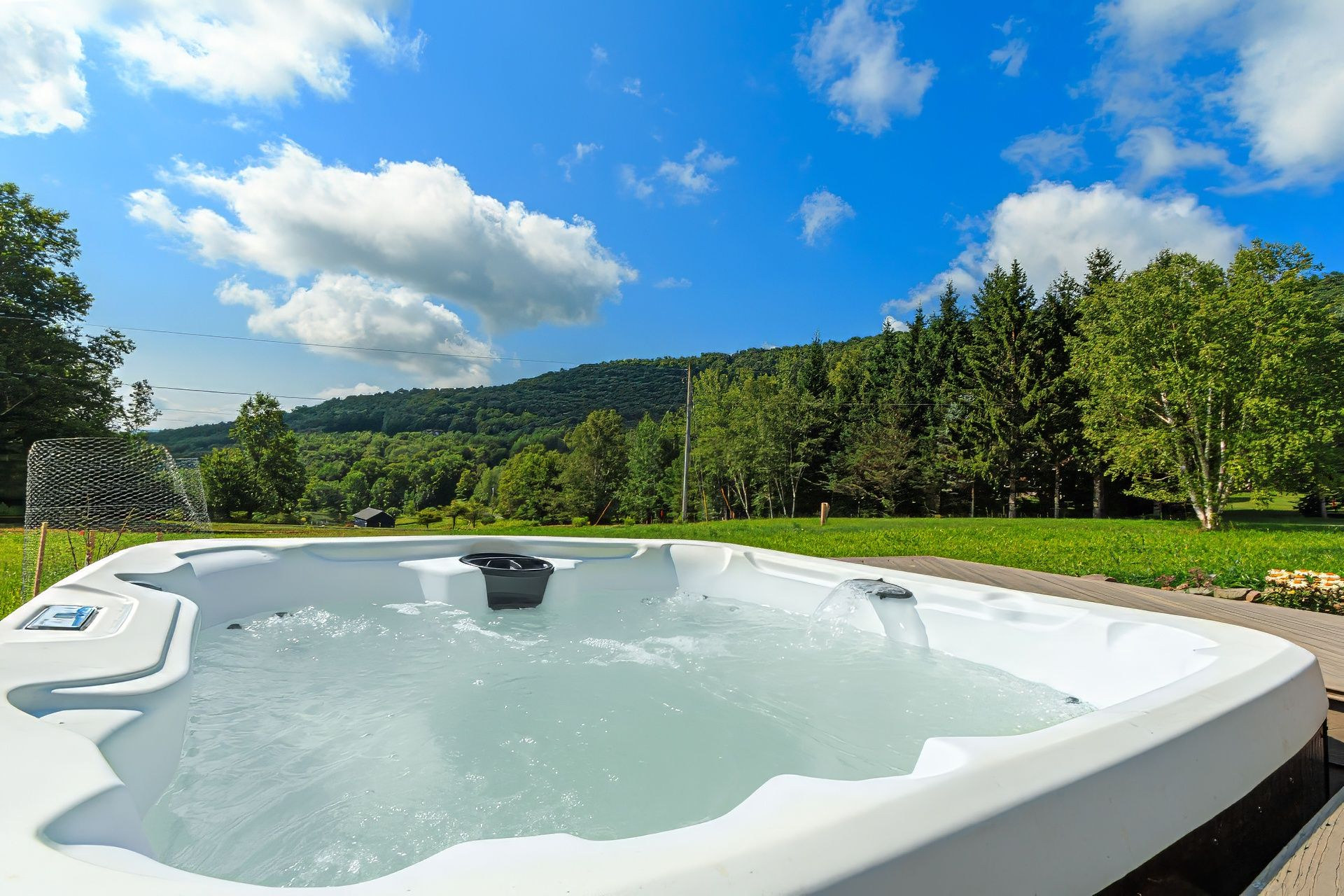 Hot tub on the deck, facing the green valley