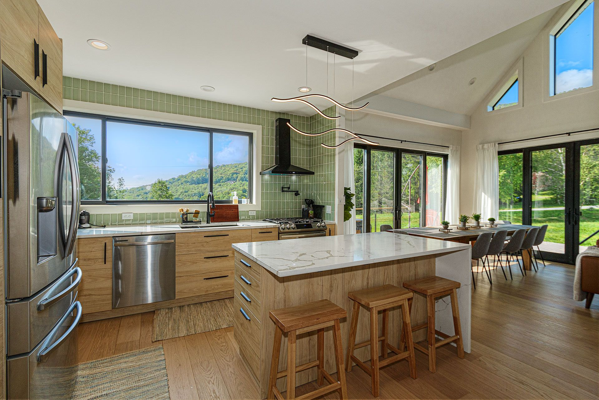 Open kitchen with waterfall island flowing into the dining room