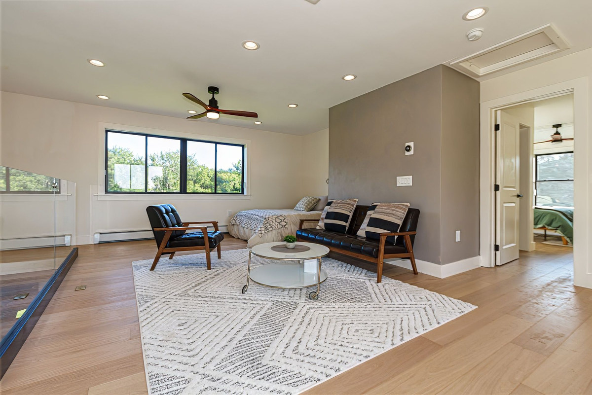 Open loft with a bed and lounge chairs