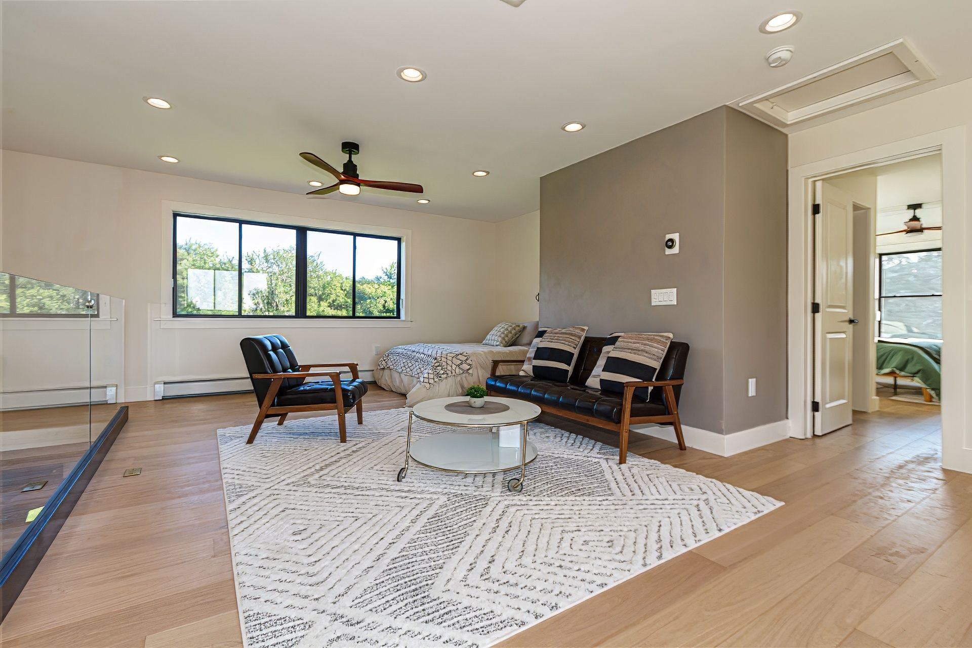 Open loft with a bed and lounge chairs