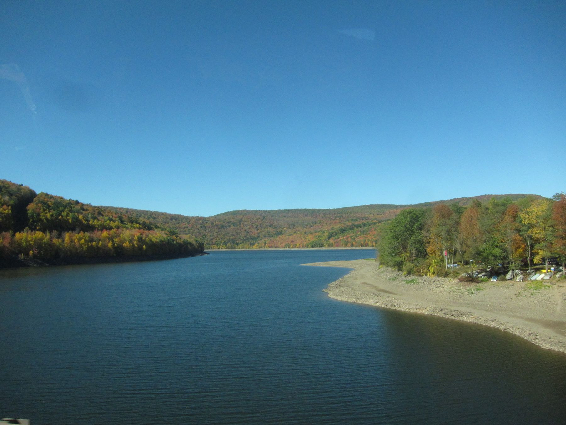 Pepacton Reservoir between wooded hills in early autumn